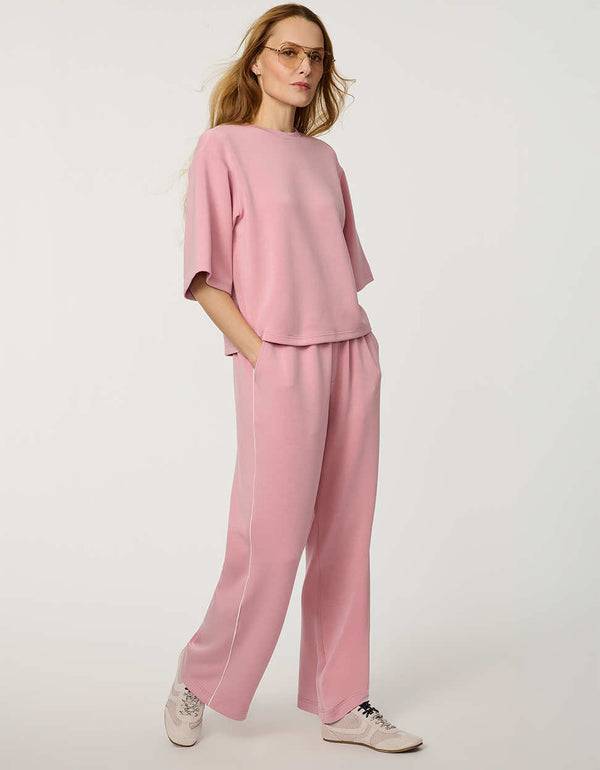 Woman wearing Relaxed Scuba Drop-Shoulder Tee with elbow-length sleeves and modern oversized silhouette.