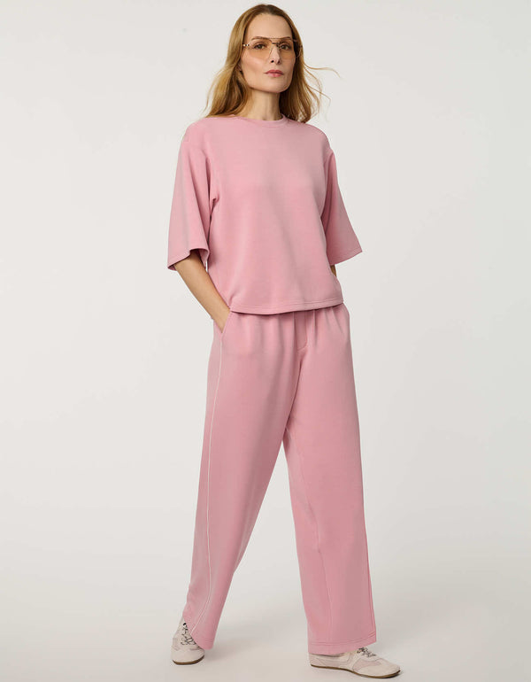 Woman wearing Relaxed Scuba Drop-Shoulder Tee with elbow-length sleeves and modern oversized silhouette.