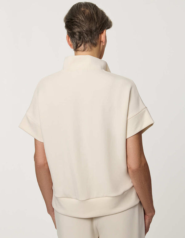 Woman wearing Half-Zip Scuba Pullover Top with stand collar and short sleeves.