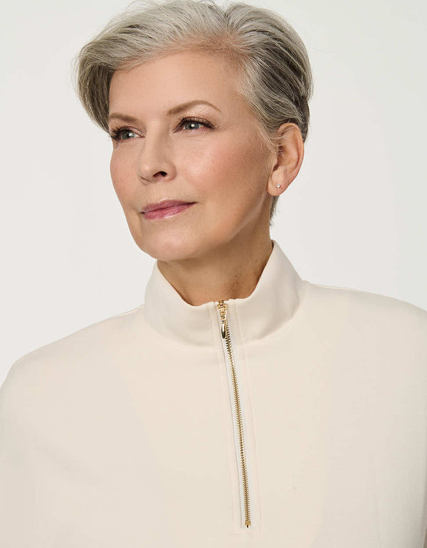 Woman wearing Half-Zip Scuba Pullover Top with stand collar and short sleeves.