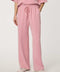 Woman wearing wide-leg Scuba Pull-On Pant with elastic waistband and subtle piping detail.