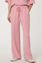Woman wearing wide-leg Scuba Pull-On Pant with elastic waistband and subtle piping detail.