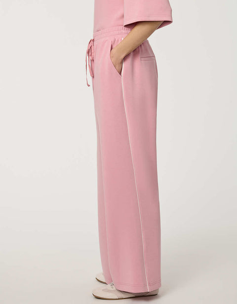 Woman wearing wide-leg Scuba Pull-On Pant with elastic waistband and subtle piping detail.