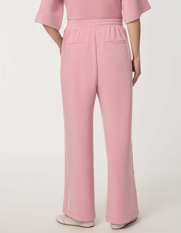 Woman wearing wide-leg Scuba Pull-On Pant with elastic waistband and subtle piping detail.