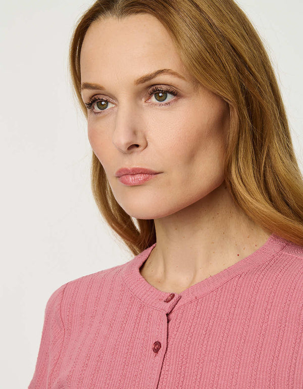 Woman wearing fitted Ribbed Button-Down Tee with short sleeves and full front button closure.