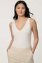 Women’s fitted jersey V-neck bodysuit in Bright White with sleeveless silhouette and smooth finish.