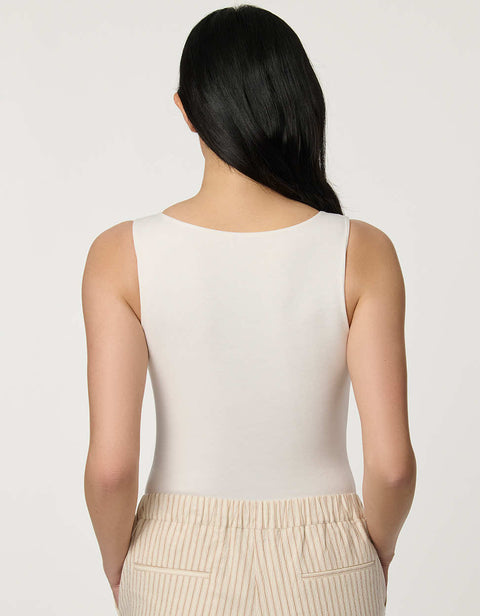 Women’s fitted jersey V-neck bodysuit in Bright White with sleeveless silhouette and smooth finish.