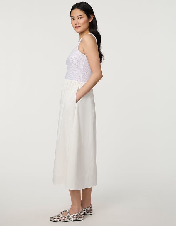 Women’s bright white eyelet midi dress with fitted perforated knit bodice and flowy A-line skirt.