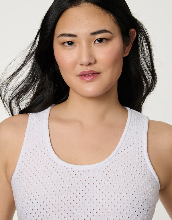 Women’s bright white eyelet midi dress with fitted perforated knit bodice and flowy A-line skirt.