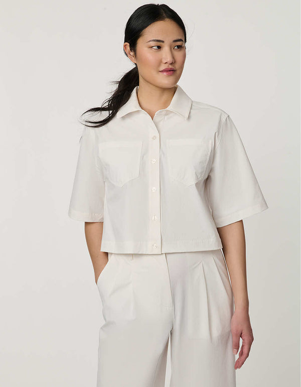 Women’s bright white cropped poplin shirt with short sleeves, button front, patch pockets, and relaxed fit.