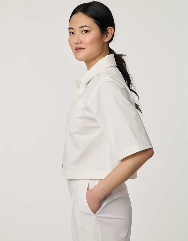 Women’s bright white cropped poplin shirt with short sleeves, button front, patch pockets, and relaxed fit.