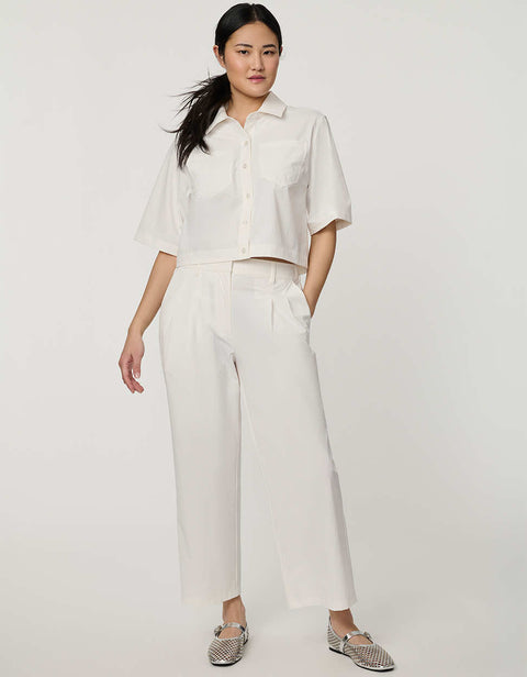 Women’s bright white cropped poplin shirt with short sleeves, button front, patch pockets, and relaxed fit.
