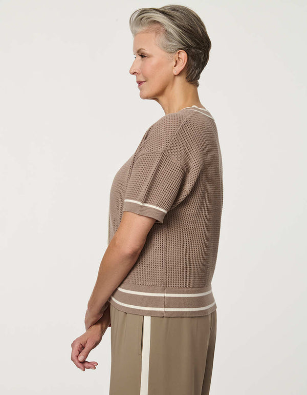 Woman wearing short-sleeve Basketweave Knit Cardigan with textured knit pattern and contrast trim detailing.