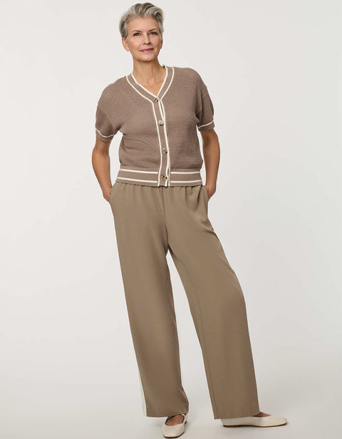 Woman wearing short-sleeve Basketweave Knit Cardigan with textured knit pattern and contrast trim detailing.