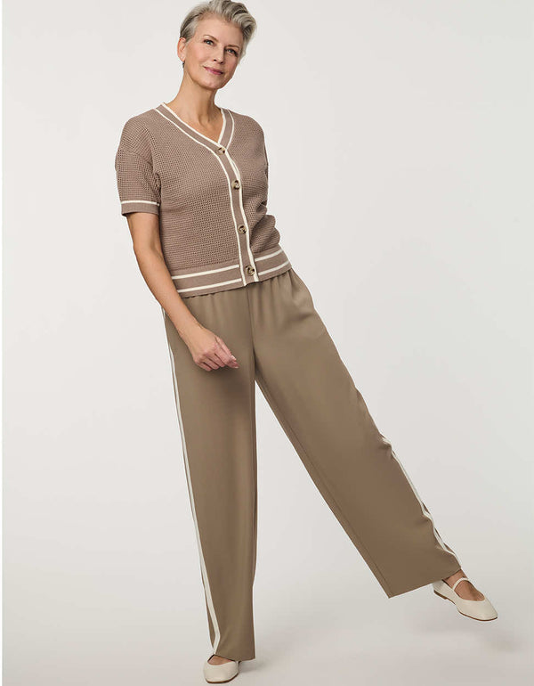 Woman wearing short-sleeve Basketweave Knit Cardigan with textured knit pattern and contrast trim detailing.