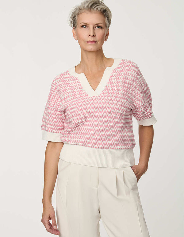 Woman wearing short-sleeve Jacquard Knit Popover Sweater with textured pattern and V-neckline.