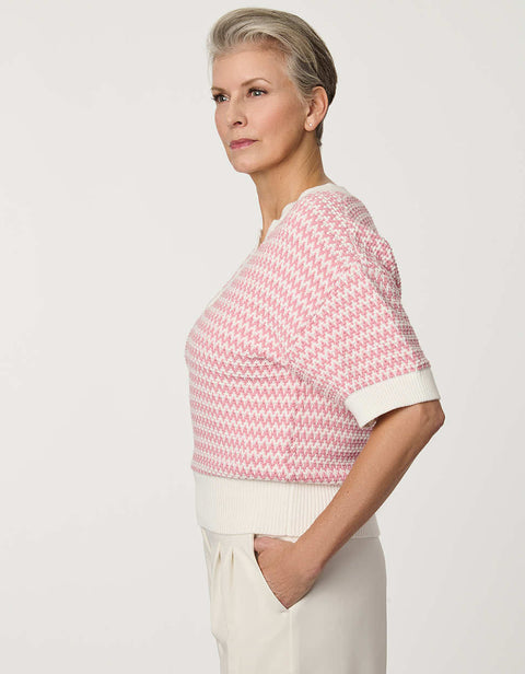 Woman wearing short-sleeve Jacquard Knit Popover Sweater with textured pattern and V-neckline.