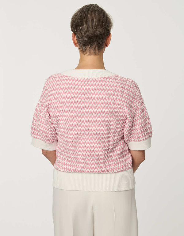 Woman wearing short-sleeve Jacquard Knit Popover Sweater with textured pattern and V-neckline.