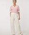 Woman wearing short-sleeve Jacquard Knit Popover Sweater with textured pattern and V-neckline.