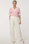 Woman wearing short-sleeve Jacquard Knit Popover Sweater with textured pattern and V-neckline.