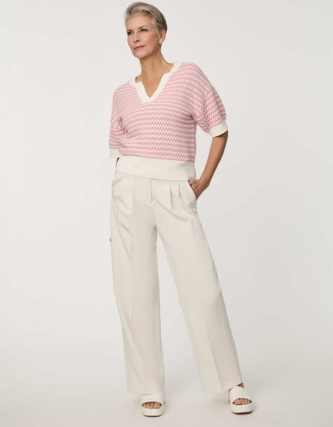 Woman wearing short-sleeve Jacquard Knit Popover Sweater with textured pattern and V-neckline.