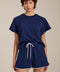 Woman wearing cropped short sleeve tee in featherweight scuba with contrast trim detail and relaxed fit.