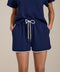 Woman wearing dolphin featherweight scuba shorts with elastic drawstring waist and contrast trim detail.
