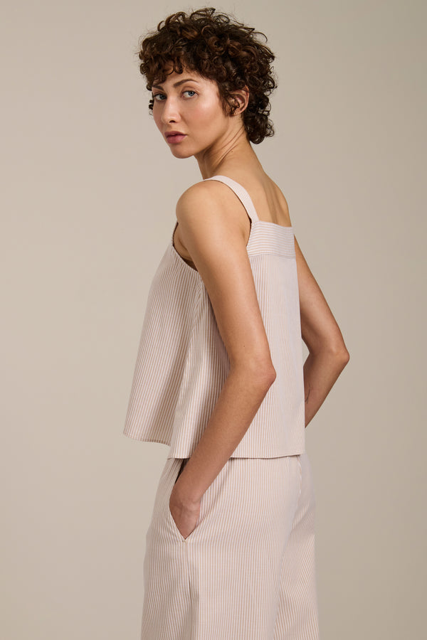 Woman wearing striped sleeveless tank top with square neckline and relaxed fit.