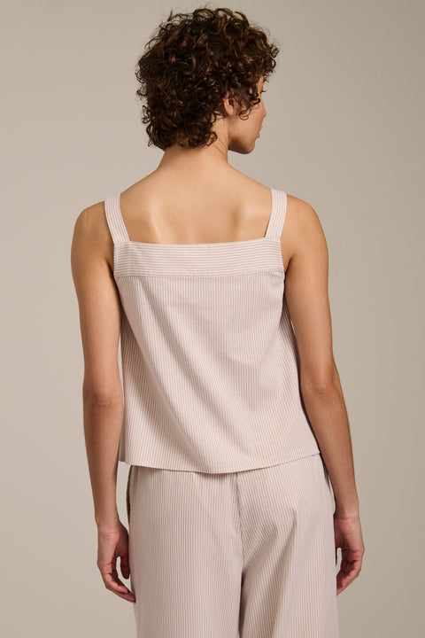 Woman wearing striped sleeveless tank top with square neckline and relaxed fit.