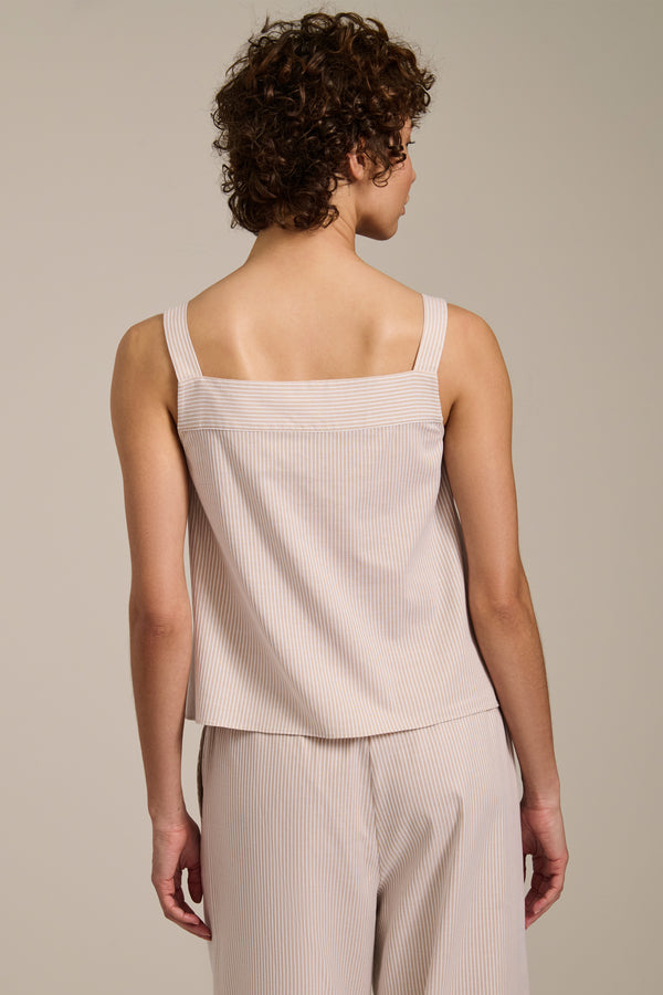Woman wearing striped sleeveless tank top with square neckline and relaxed fit.