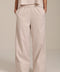 Woman wearing striped wide leg pants with elastic waistband and relaxed silhouette.
