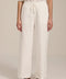 Woman wearing jacquard plaid relaxed pants with elastic drawstring waist and straight leg silhouette.