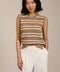 Woman wearing sleeveless striped pointelle knit top with textured openwork detailing.