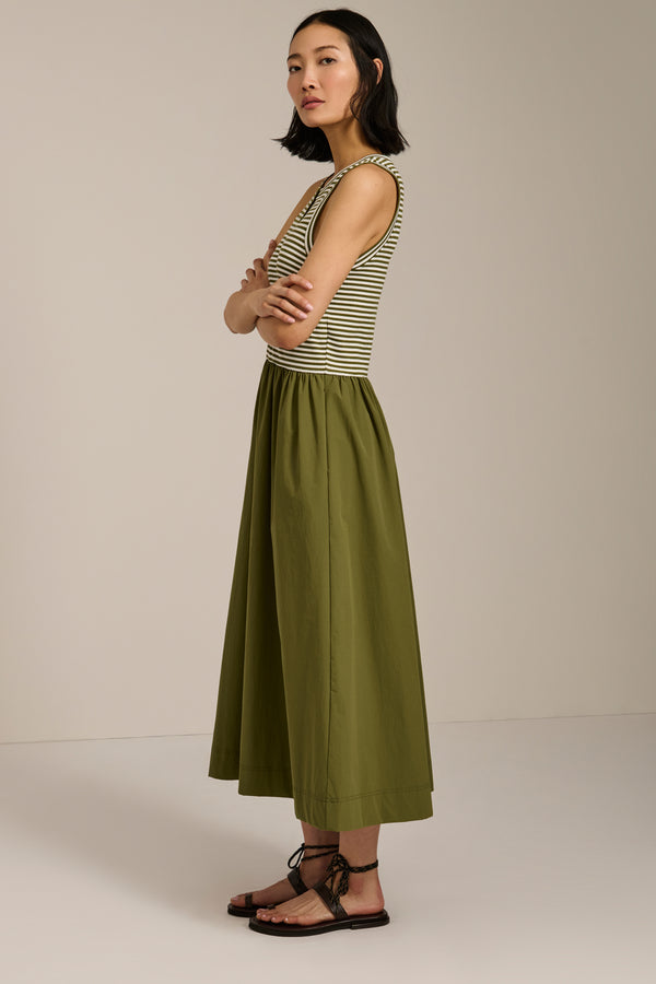 Woman wearing striped sleeveless midi dress with knit bodice and full poplin skirt.