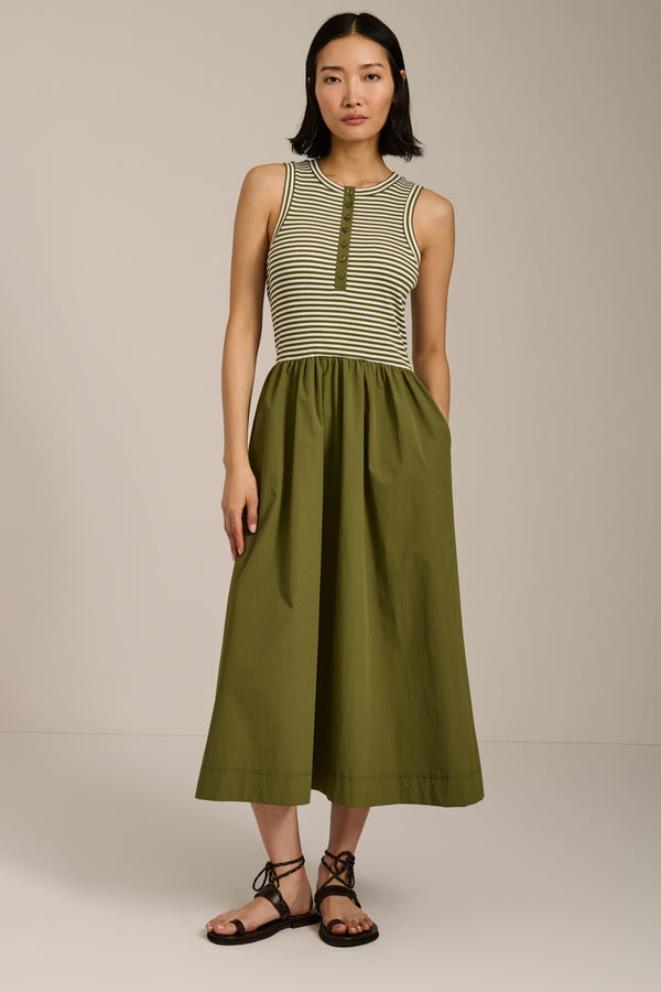 Woman wearing striped sleeveless midi dress with knit bodice and full poplin skirt.