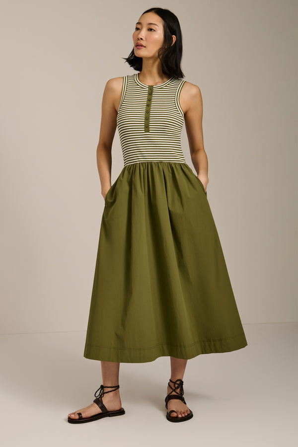 Woman wearing striped sleeveless midi dress with knit bodice and full poplin skirt.
