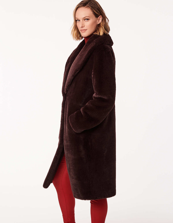 elegant cherry wood faux fur coat featuring a classic fit wide lapels and deep pockets perfect for colder days