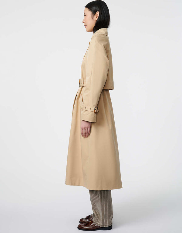 water resistant long trench coat with belt and button closure hand pockets and an inverted box pleat