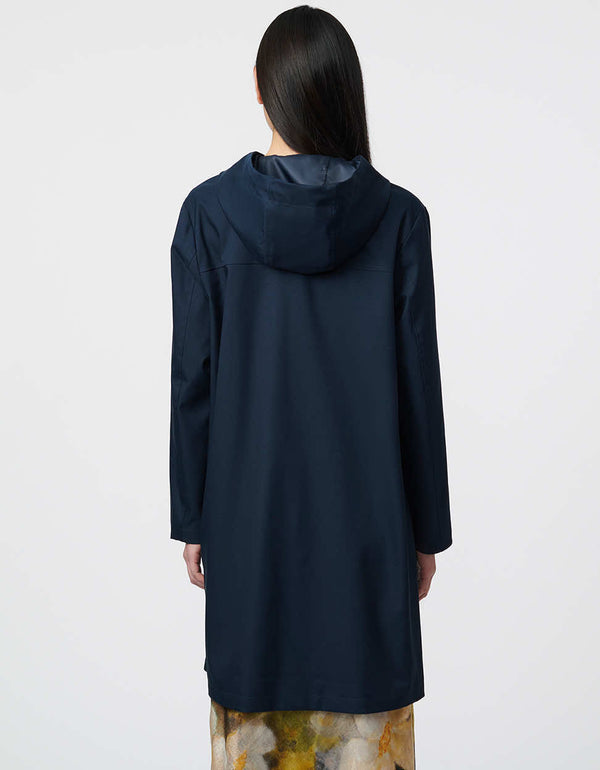 shield yourself from the rain in this oversized navy color mid length raincoat with adjustable hood