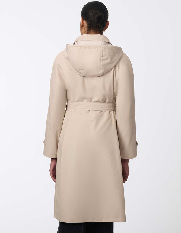 hip length and classic fitting trench coat for women made with water resistant fabric and removable hood in a taupe