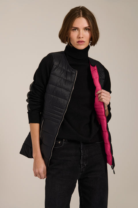 women's reversible black and pink puffer vest.