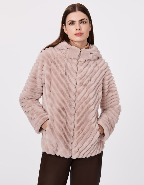 cozy and comfortable vegan fur hooded jacket with hand pockets as womens winter jacket in light pink
