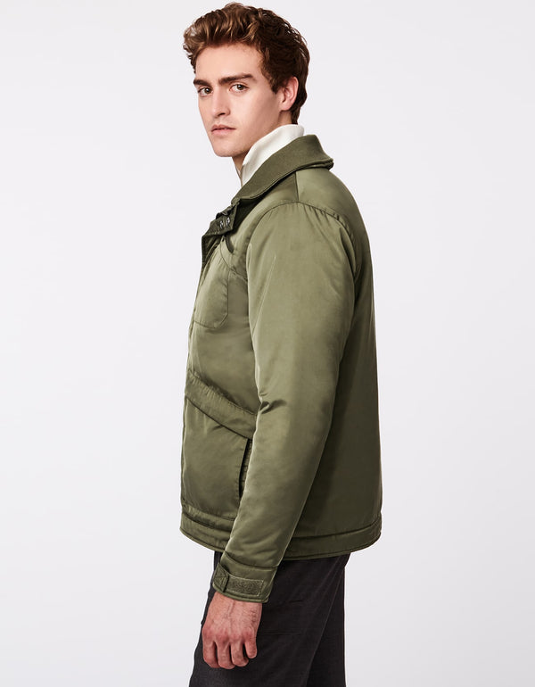 hip length puffer jacket in olive green with concealed closure and double snap styling at the ample knit lined collar