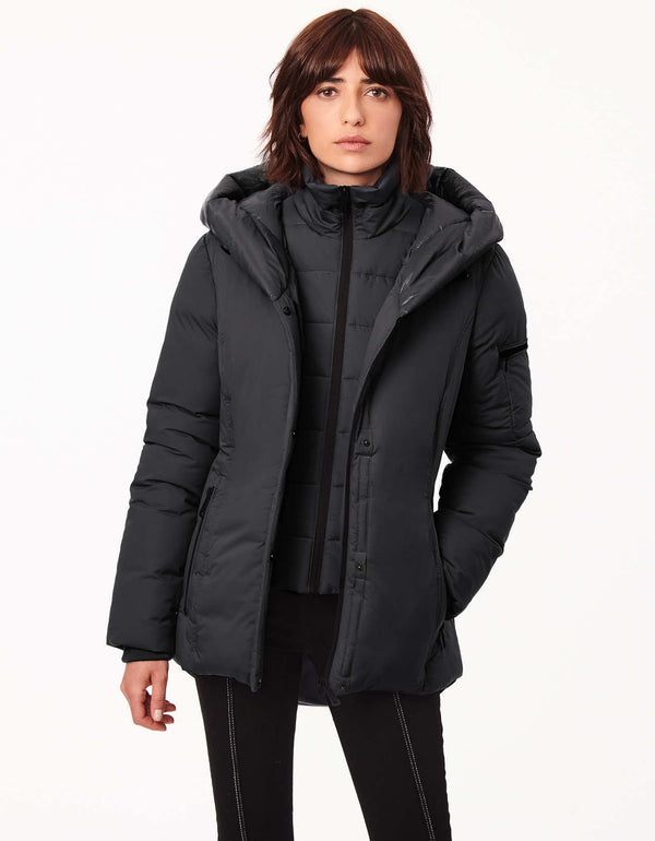 woman in hip length puffer jacket and heavy winter coat in one to help her stay warm in all season long