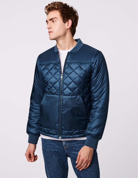 classic quilted mens puffer jacket in black with hand pockets and sustainable filler for insulation as fall clothing essential for men