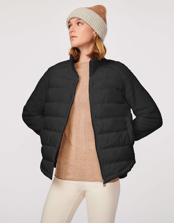 womens stylish high low puffer jacket in black with a warm and sustainable filler and high low hem