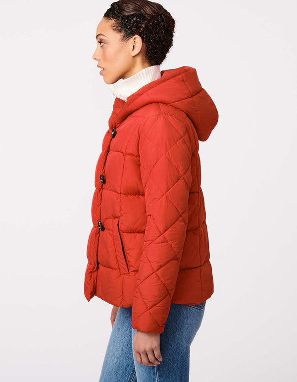 eco friendly red puffer jacket for women that is square stitched and has a diagonal sleeve design