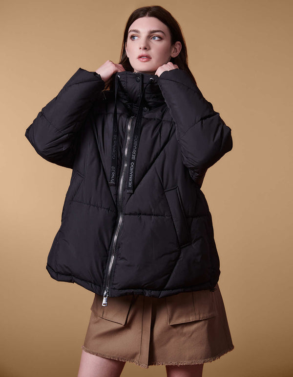 chic and trendy hooded puffer coat in black with welted pockets in mid length designed for maximum movement and comfort