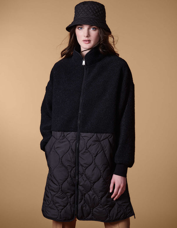 long quilted puffer coat for women with ribbed cuffs two way zipper and a side seam zipper that extends to the waist seam