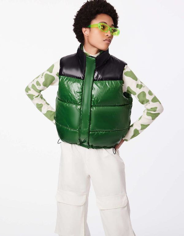 hip and stylish womens puffer vest in winter street style in bold colors green black with a sheen fabric mix and classic fitted style